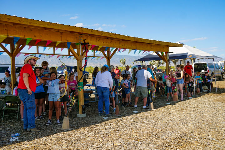 Kids line up under the new shade structure for target practice during summer classes.