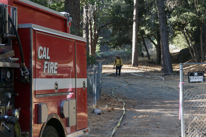 Cal Fire crew hikes up the canyon to put out a small fire start.