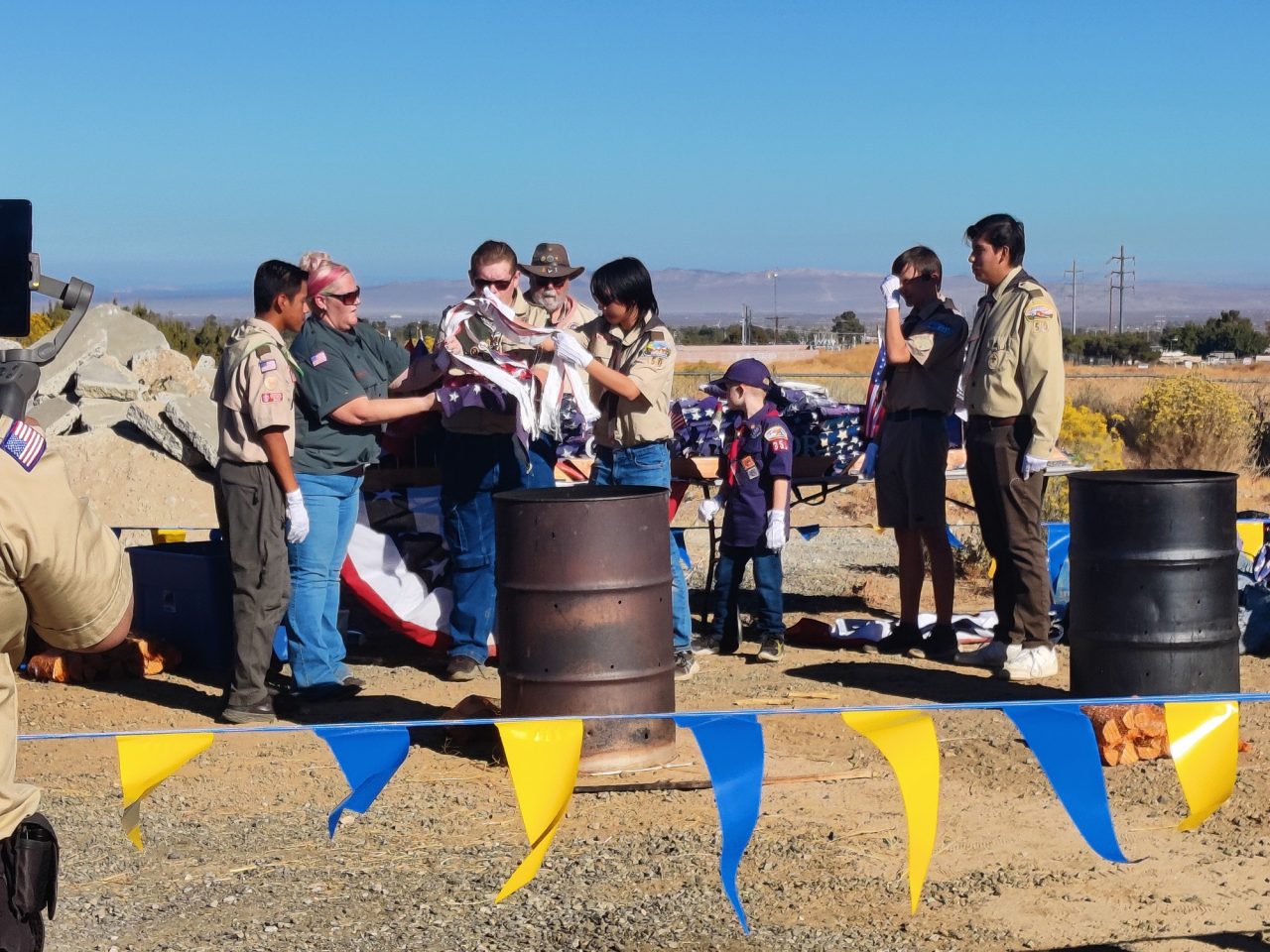 The stripes of the flag are placed back onto the stars, before being retired into the fire.