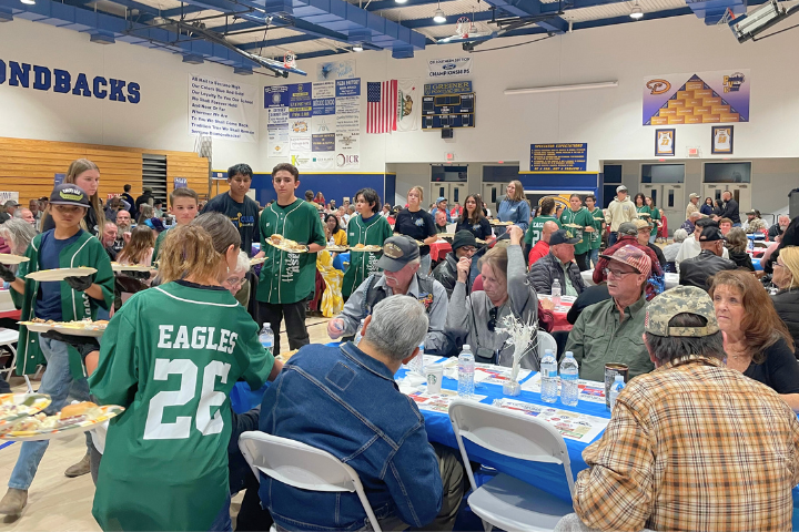 Dinner is served: Snowline students serve meals to the honored guests.