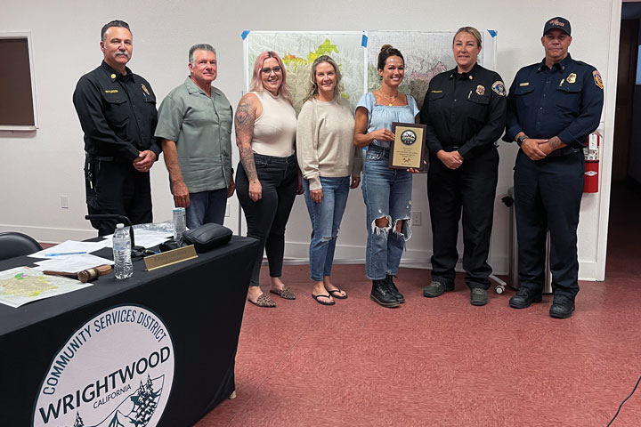 October: Pictured left to Right: County & State Fire Officials present, newly appointed WCSD Board Member Kurt Watson, WCSD Board Members with an award of appreciation for their work during the Bridge Fire.