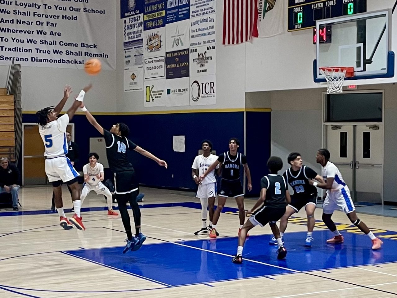 Senior, Jontae Blandon (#5), takes a shot at the top of the key during the CIF playoff game.