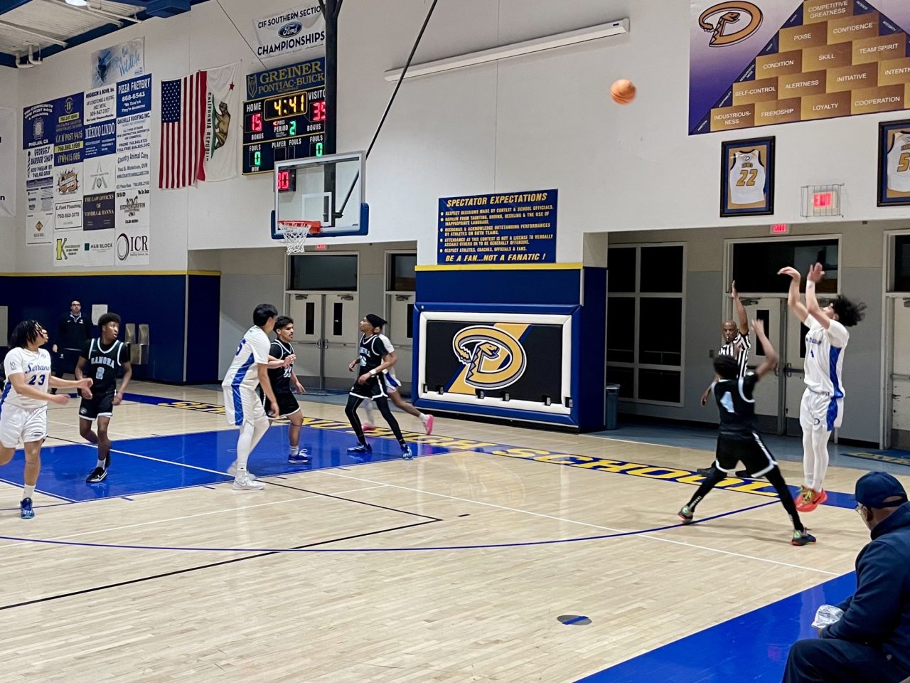 Junior, Frank Maldonado (#4) attempts a three-point shot during the first half of the game.