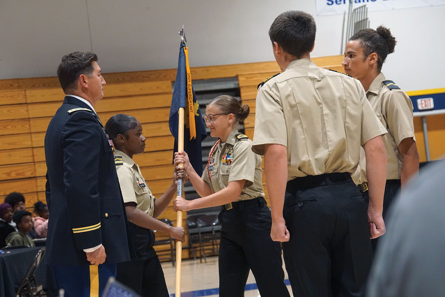 A change in Command: In her first act as the 279th Battalion commander    Cadet Sgt. 1st Class Mariah Johnson passes the guidon to Cadet Sgt. 1st Class      Coulombe naming her the new command sergeant major.