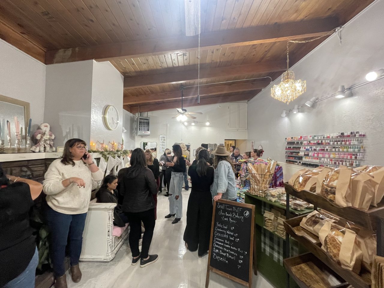 Vendors and visitors gather inside the newly remodeled Hair in the Woods salon.