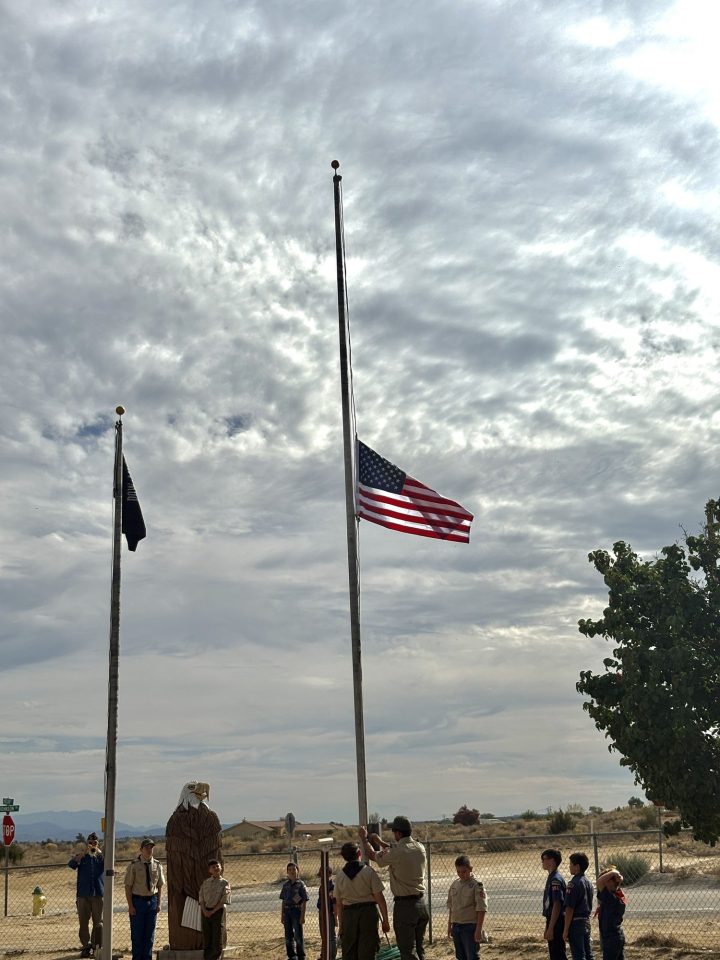 Boy Scout Troop 351 raising the American flag on Veterans Day.