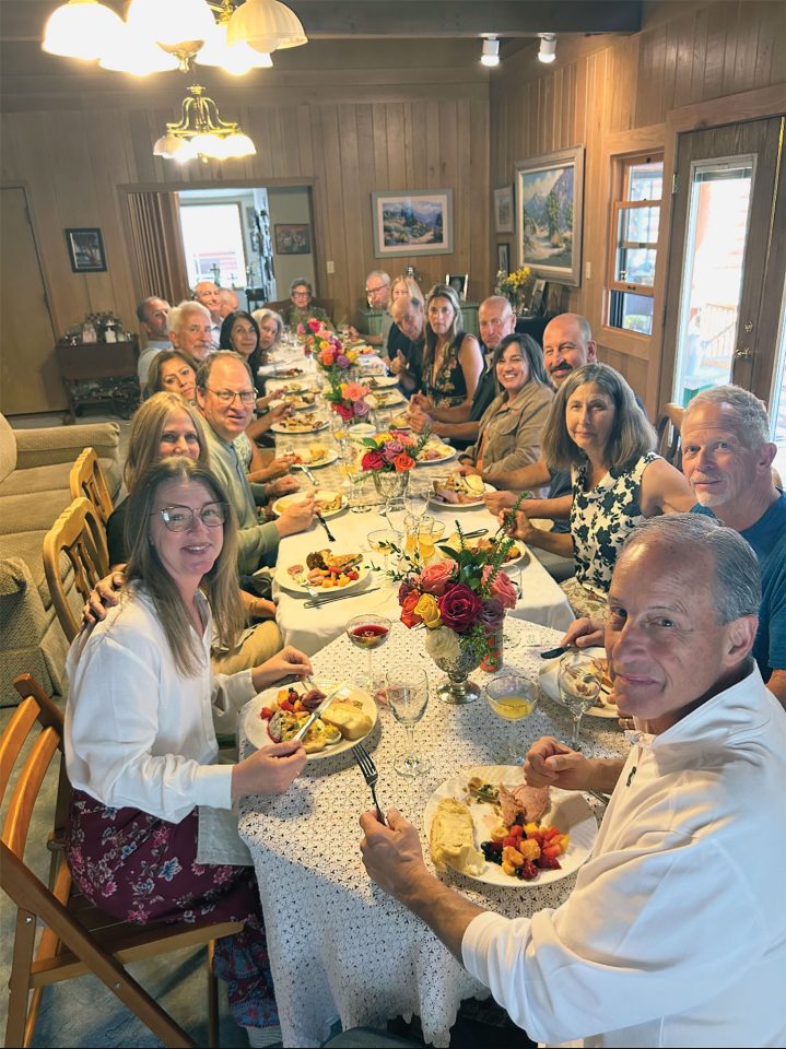 Family and friends gather around the table to celebrate Lora Steinmann’s 90th birthday during a surprise brunch at her Wrightwood home.