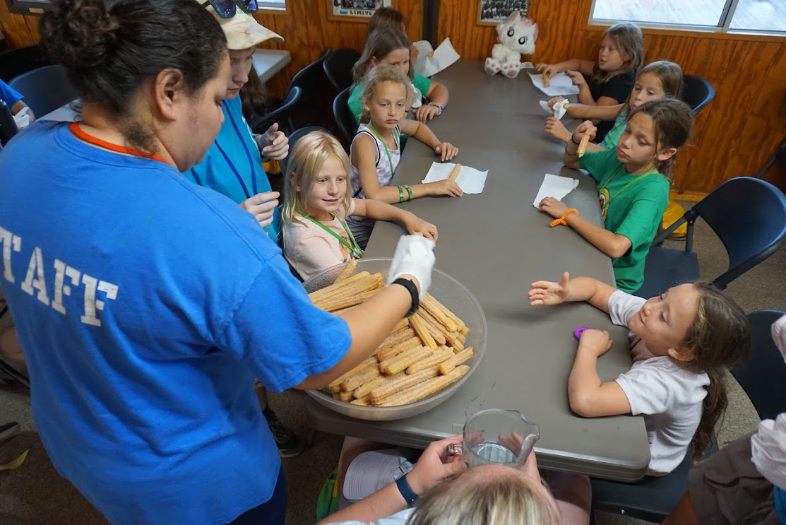 Campers enjoying donated churros