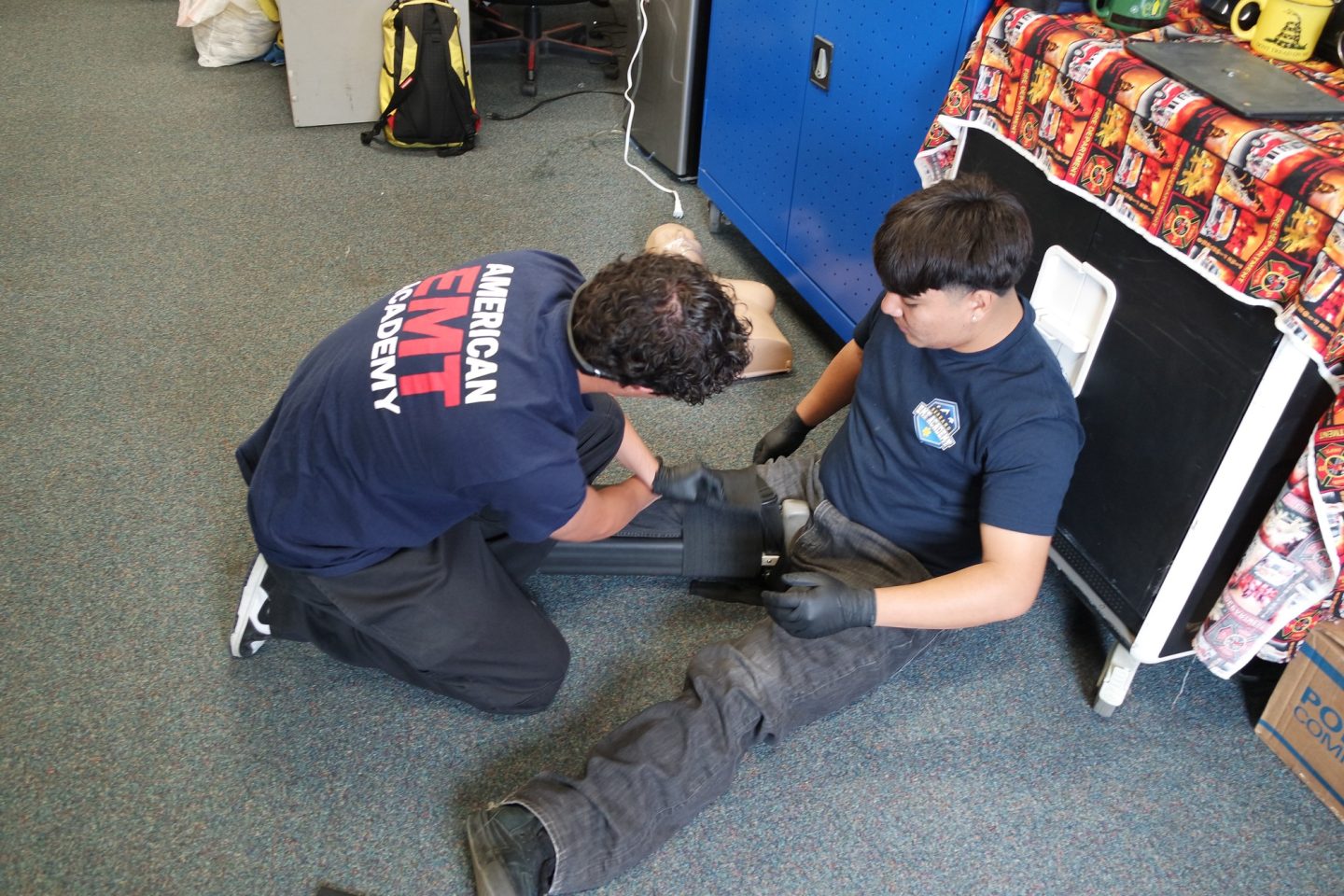 A student is practicing applying a splint to another EMT student