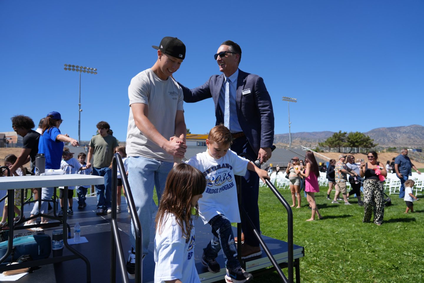 Snowline JUSD Superintendent of Education, Ryan Holman, Ed.D. on stage, taking the time to connect with each Senior and Kindergartener.